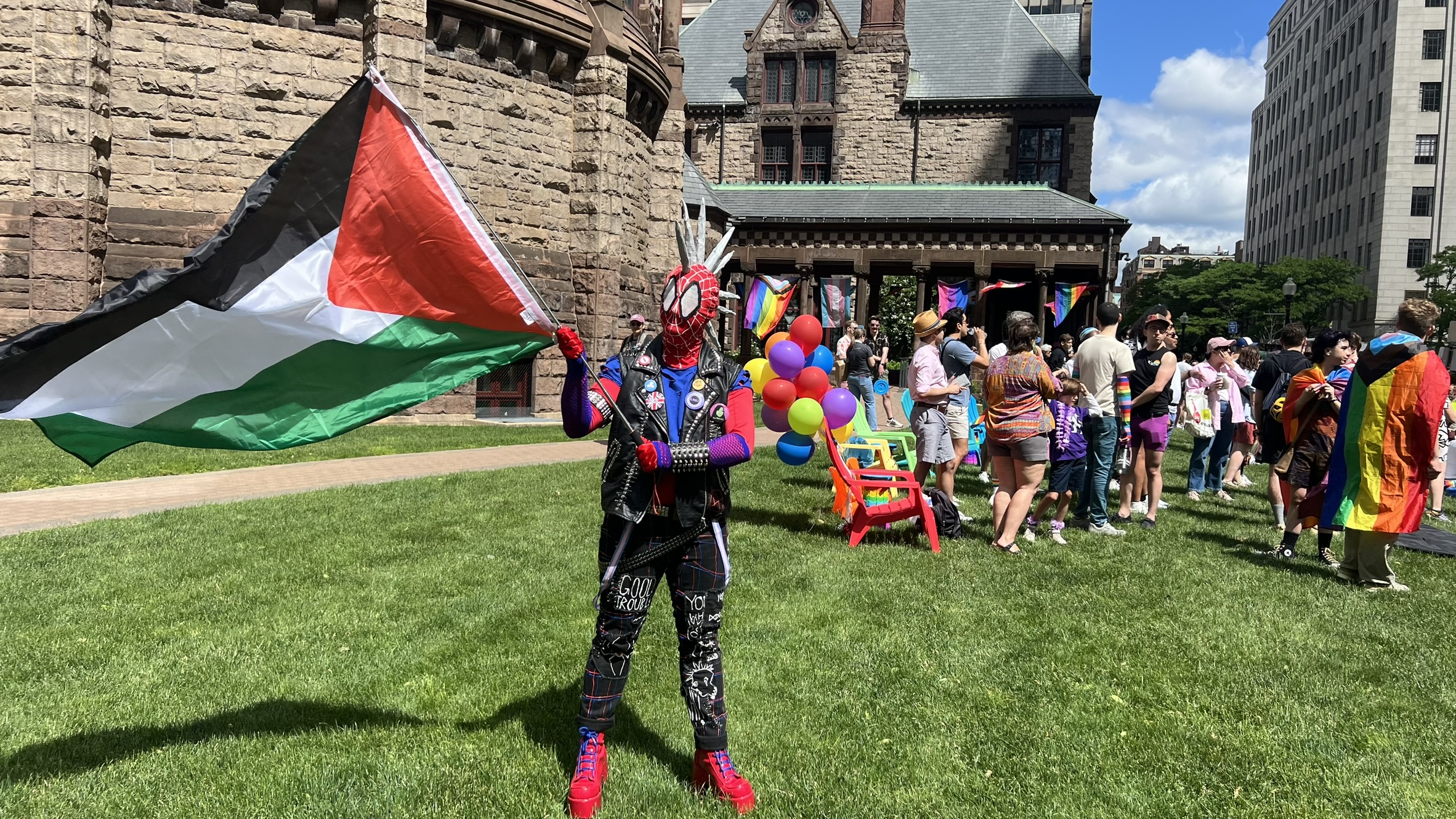 Spider-Punk cosplayer waves a Palestinian flag at a pride parade
