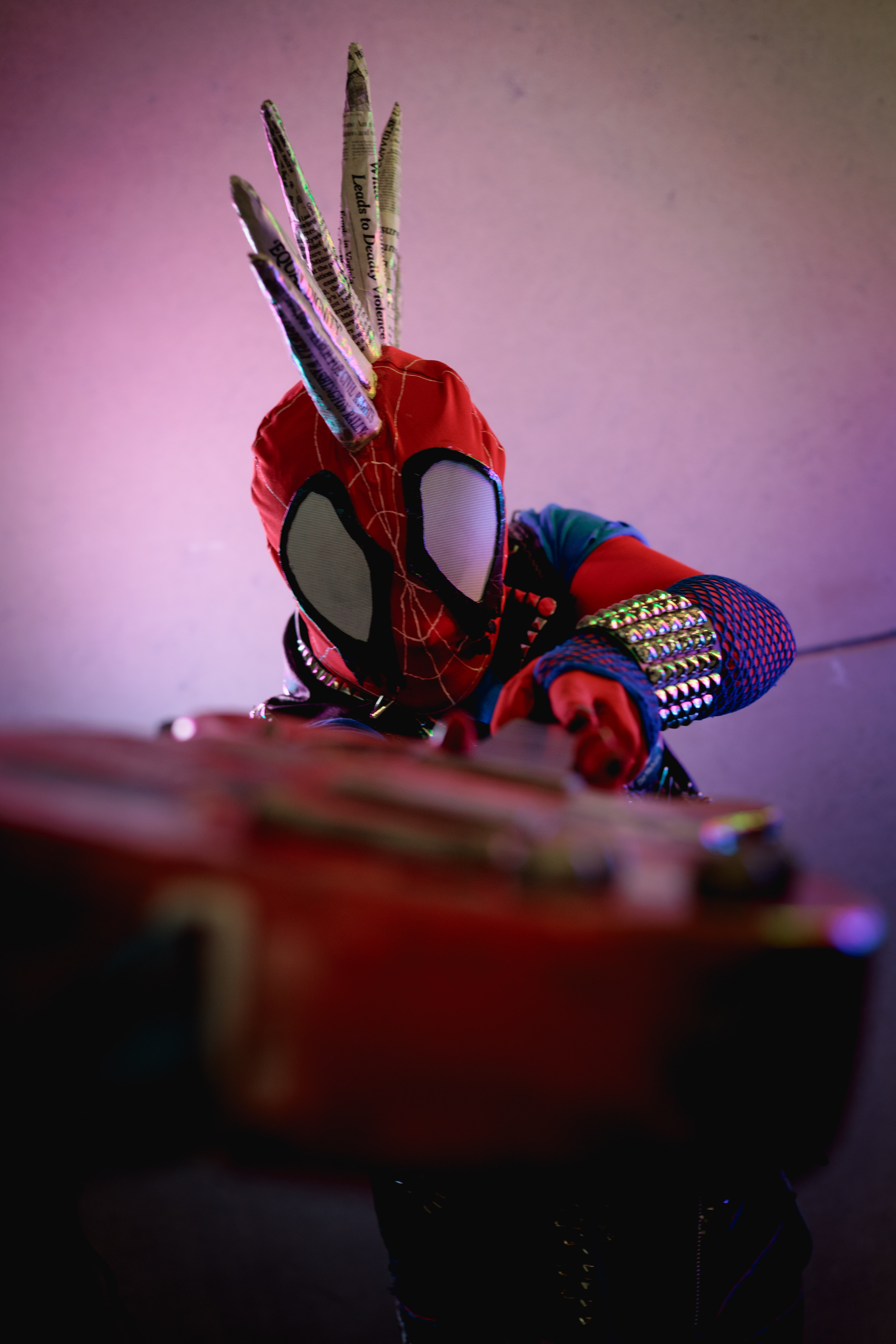 Spider-Punk cosplayer pointing guitar at camera